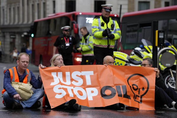 Activists from the group Just Stop Oil block a road in London, Thursday, Oct. 27, 2022 demanding to stop future gas and oil projects from going ahead.  (AP Photo/Kirsty Wigglesworth)